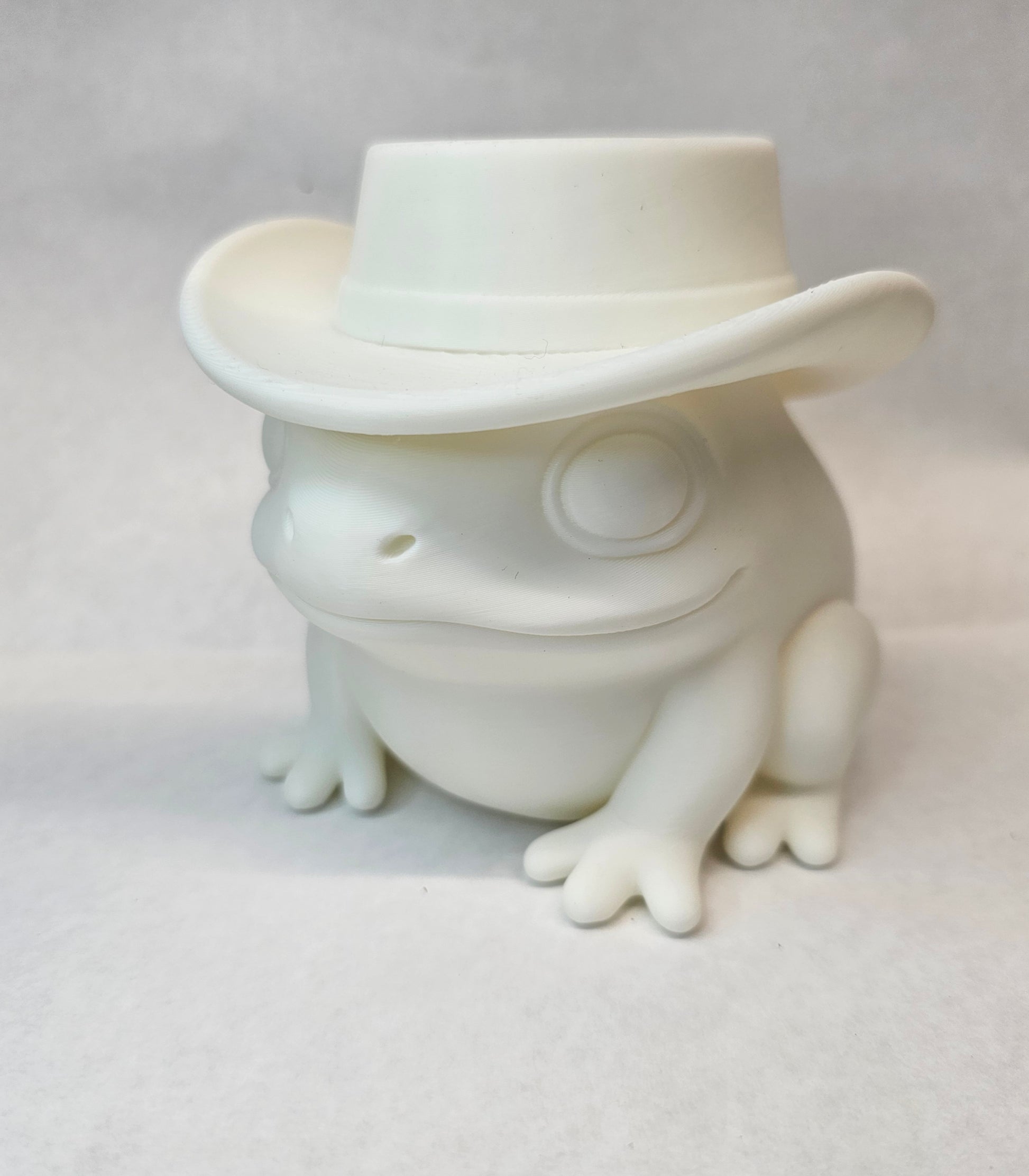 Close-up of Lonesome cowboy frog pencil and brush holder desk organizer in white PLA